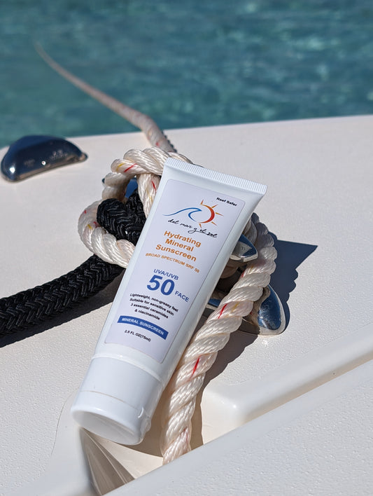 Del Mar y el Sol Hydrating Mineral Sunscreen SPF 50 tube with clear skies and ocean backdrop.