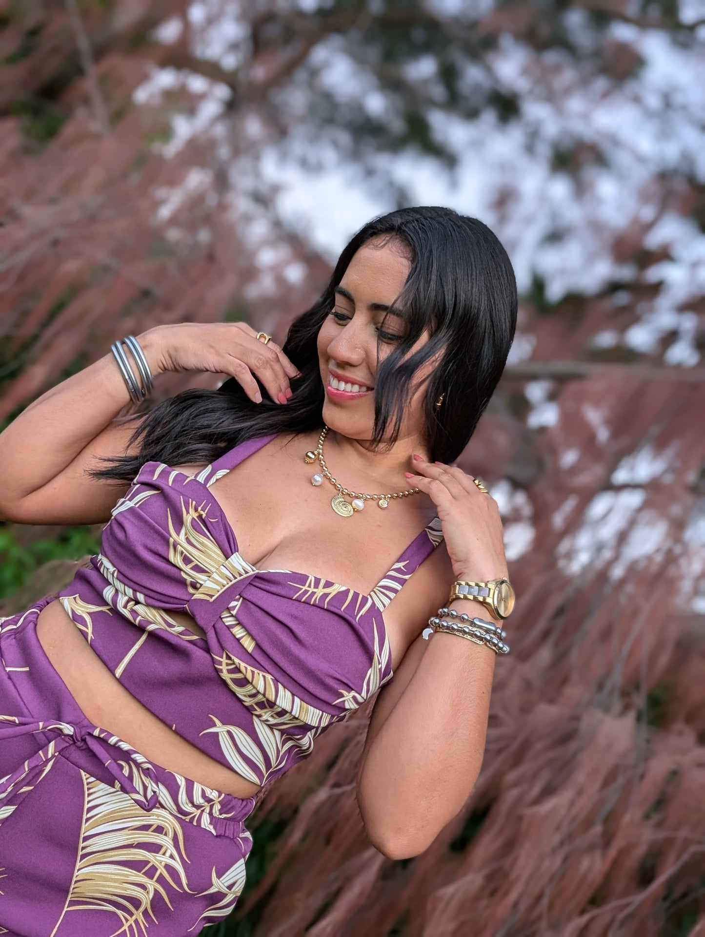 Model wearing Sol Top in tropical print with thin straps and fitted design.