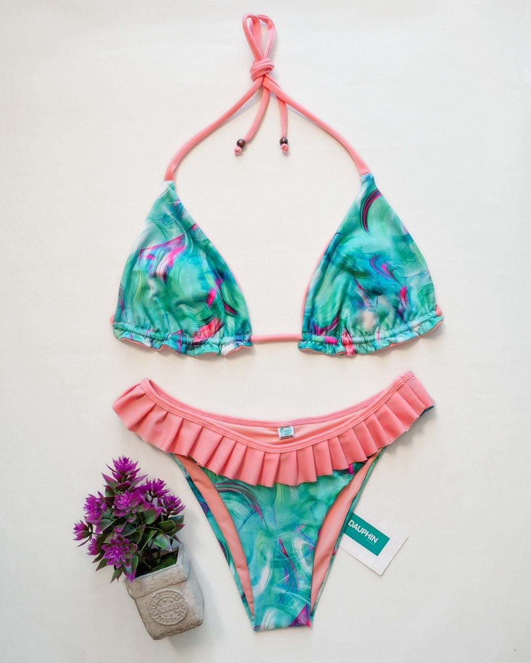 Reversible Reef bikini top with aqua and pink swirl pattern and matching Coro II bottoms with ruffle waistband.