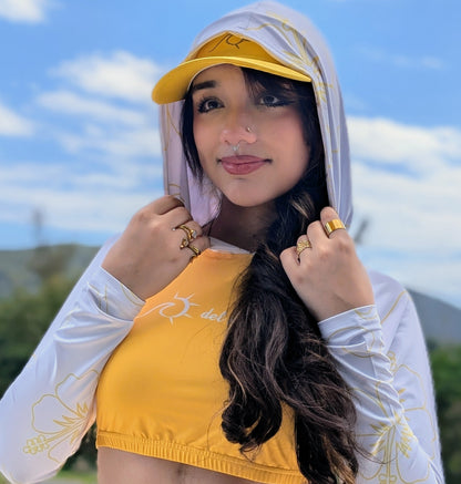 Woman wearing a yellow and white cropped rash guard with hoodie 