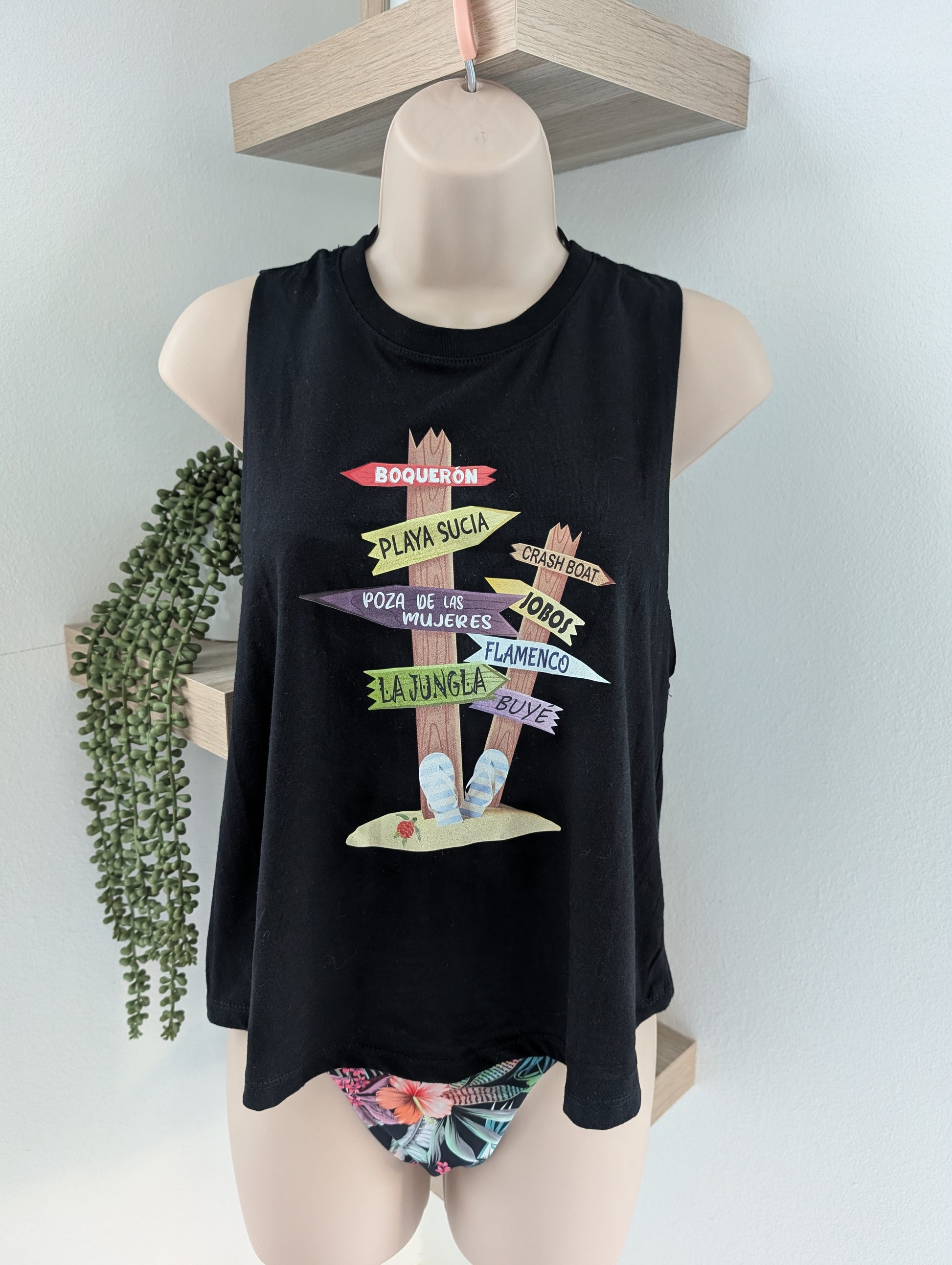 Black tank top with colorful graphic design on a mannequin against a light gray background.