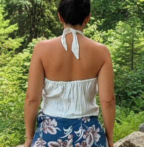 Back view of halter romper with tie closure and blue tropical floral shorts.
