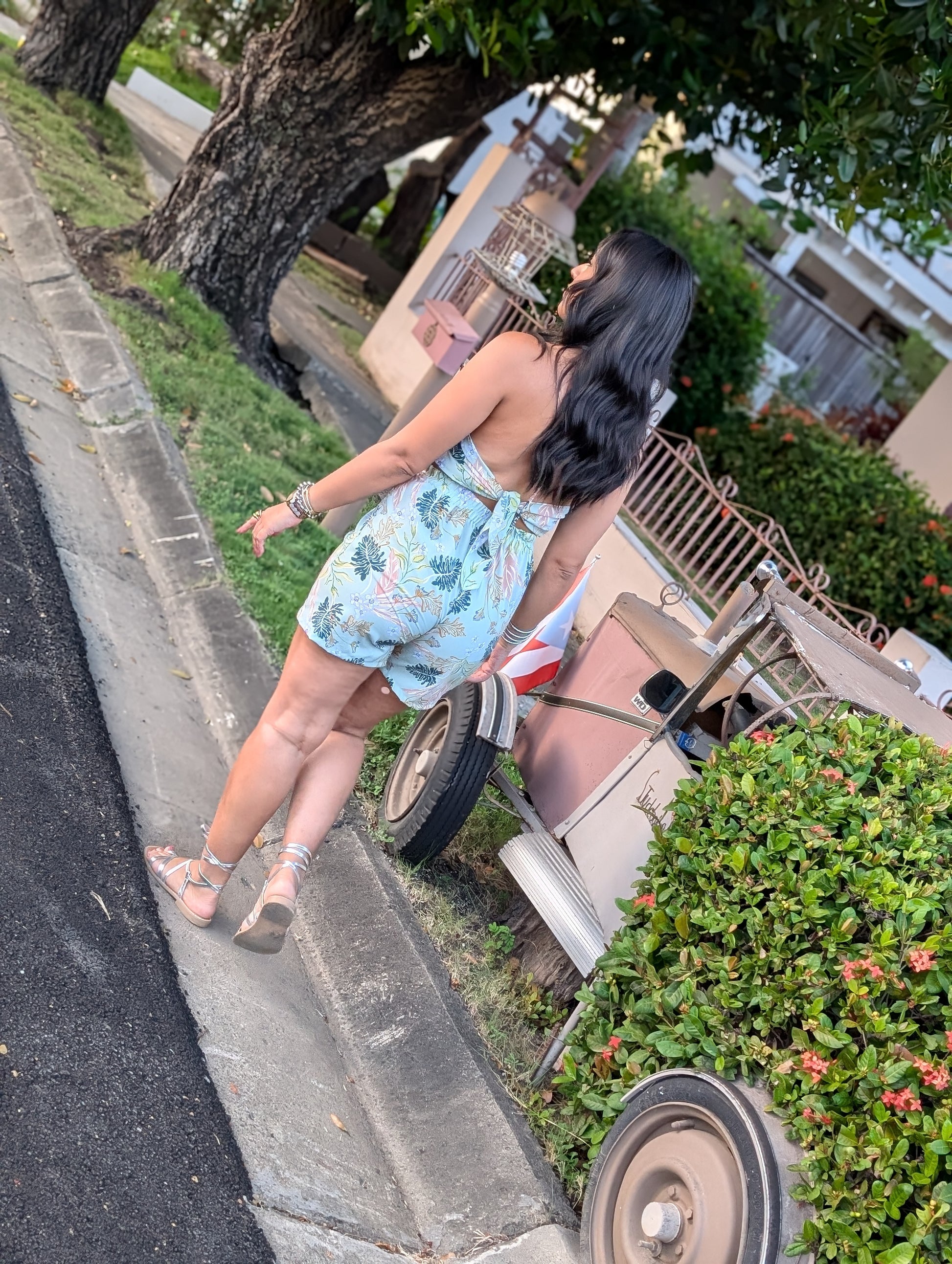 A woman walking on a street wearing a delicate soft romper