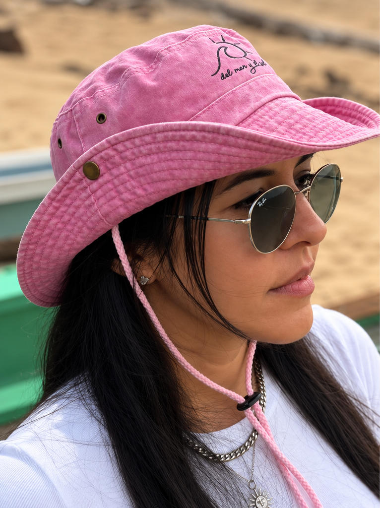 Woman wearing the Marina convertible bucket hat in Coastal Pink in its cowboy-inspired style.