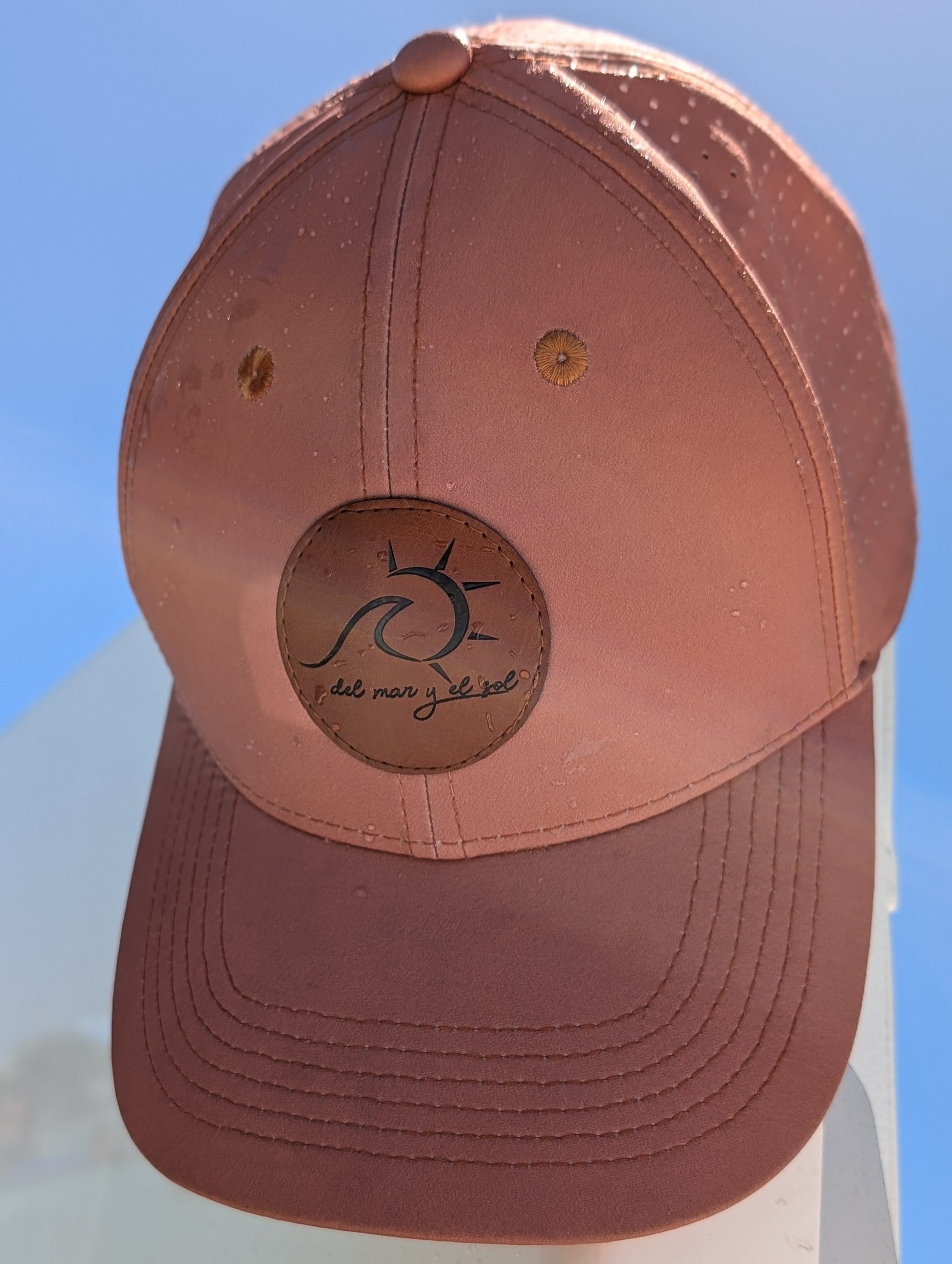 Sunset brown cap with perforated panels under tropical sun
