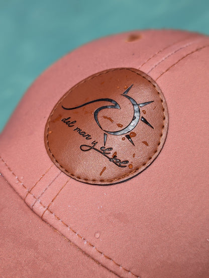 Close-up of vegan leather patch on Sunset Coral dry fit cap by Del Mar y el Sol
