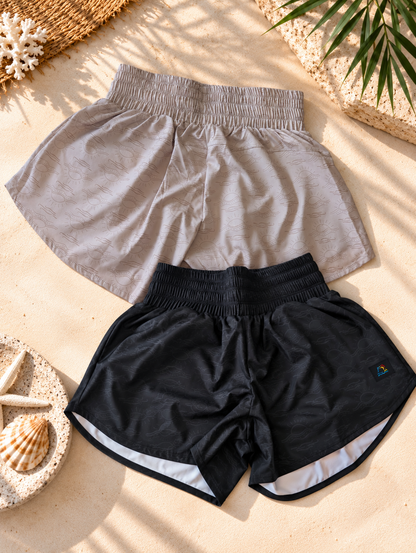 Tidal Ease quick-dry stretch beach shorts for women in Sunwashed Sand and Midnight Wave.