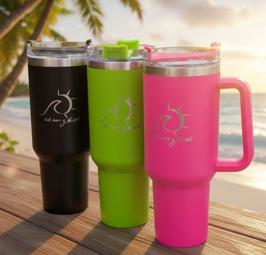 Three insulated travel mugs in black, green, and pink on a wooden surface with a blurred natural background.